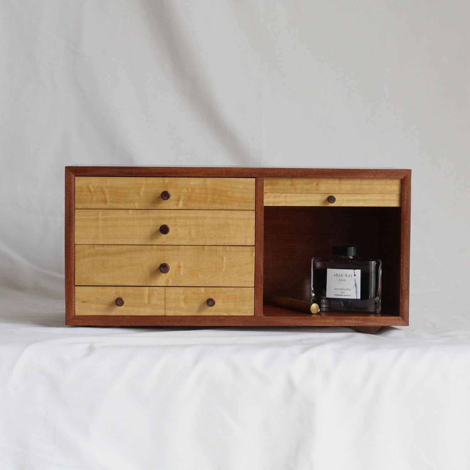 Small Chest of Drawers with a bottle of pen ink